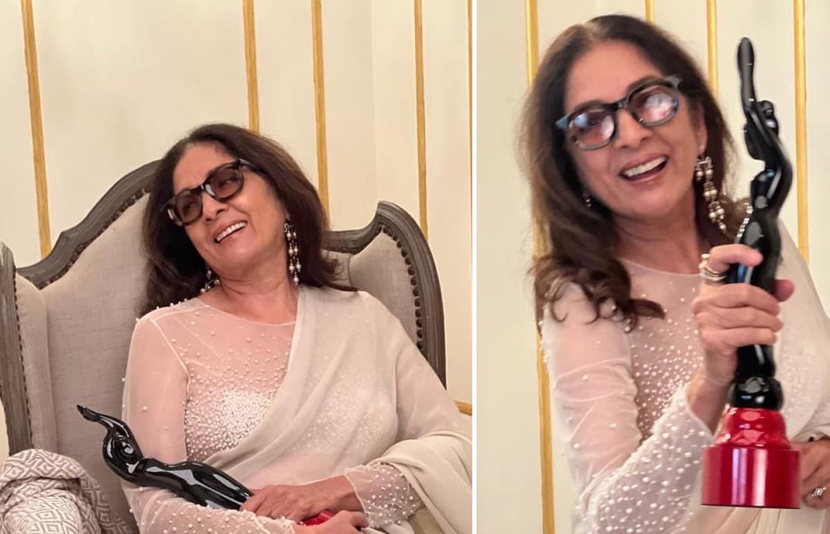 Neena Gupta celebrating her win at the 2022 Filmfare OTT awards in a vintage Wendell Rodricks sari.