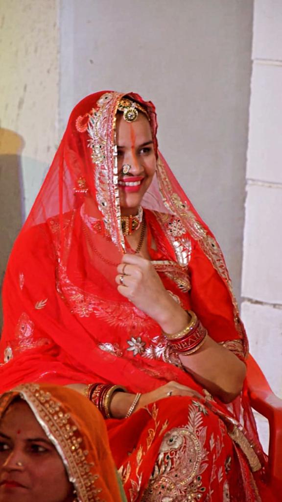 A woman photographed in a traditional Rajasthani lehenga. 