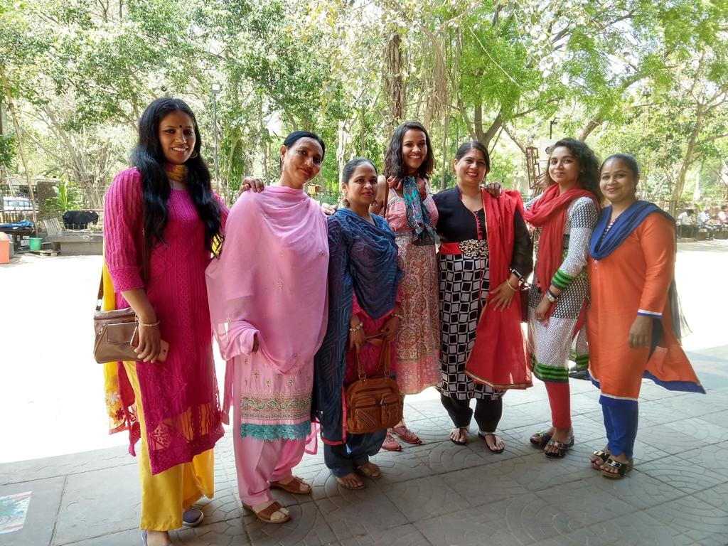 Women of an NGO posing together for a picture.