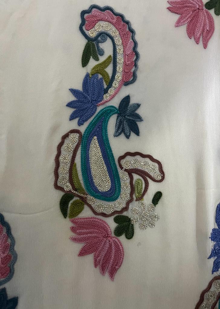 A close up of the aari and tilla Kashmiri work embroidery.