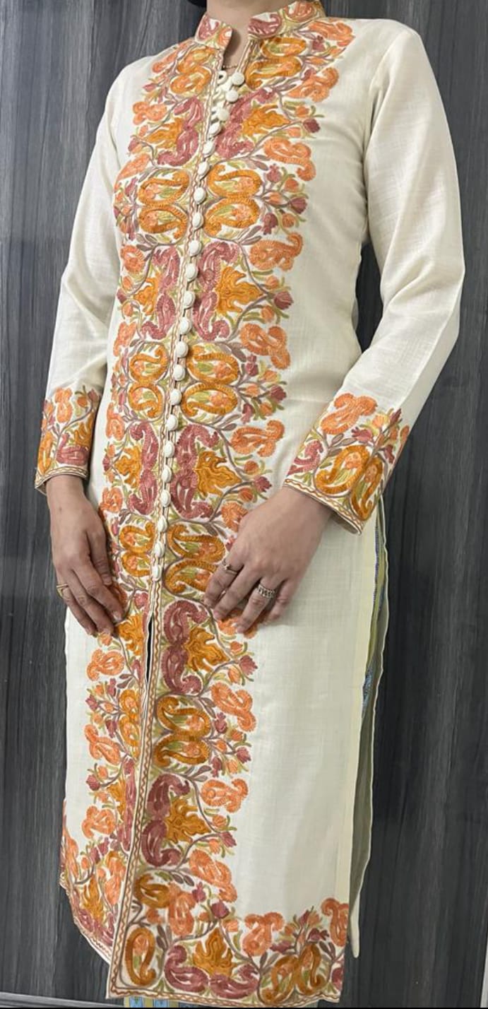 A woman wearing an embroidered Kashmiri suit.