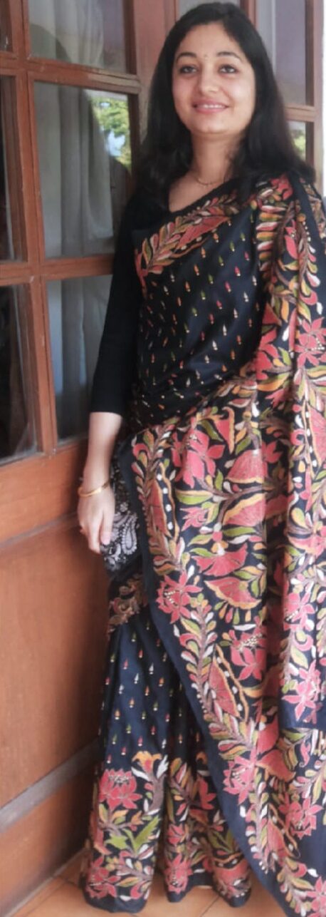 A woman in a black Kantha stitch embroidered sari.